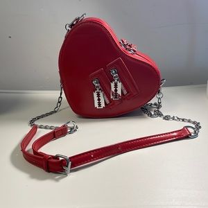 Herat shaped red bag with blade decorations
